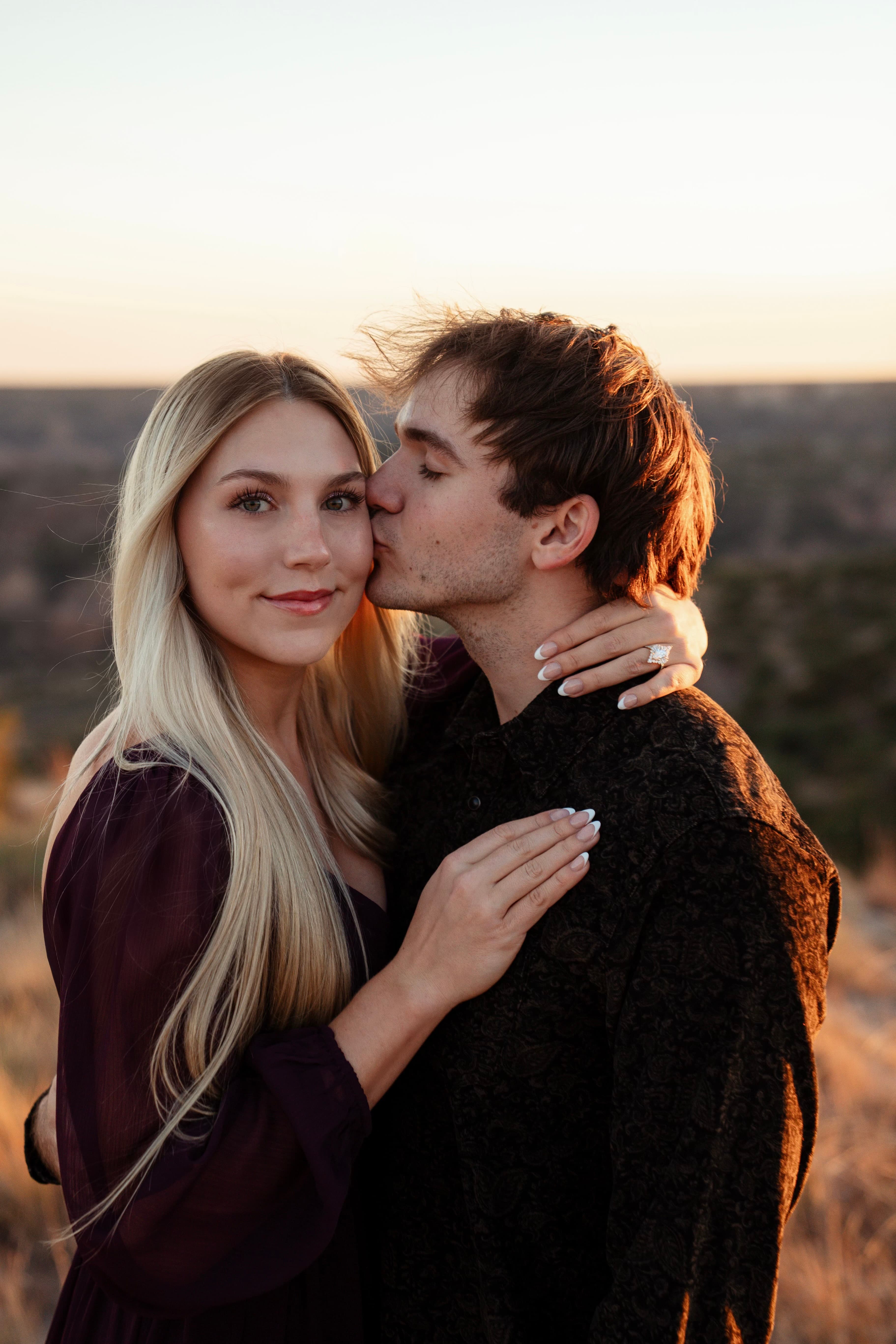 Zane kissing Brynne at golden hour